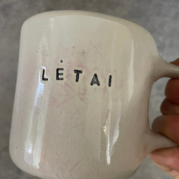Pale pink ceramic mug with word LĖTAI