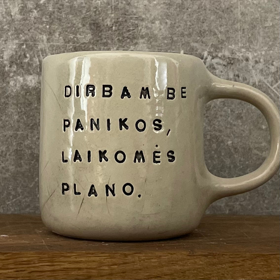 White medium ceramic mug with words about work