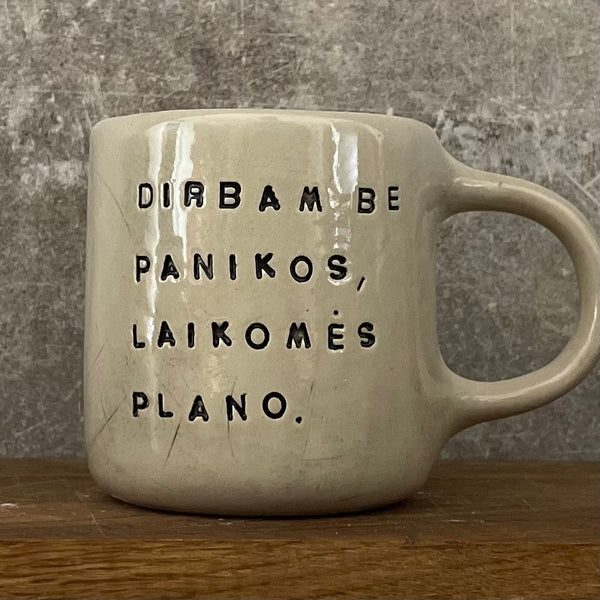 White medium ceramic mug with words about work