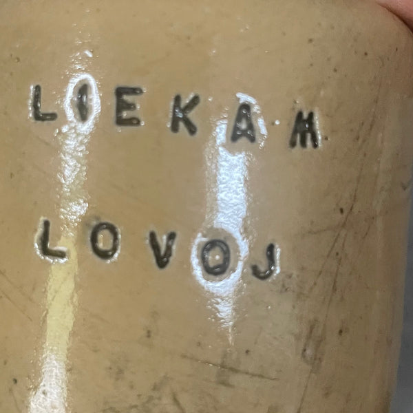 A pair of small mugs with words in Lithuanian