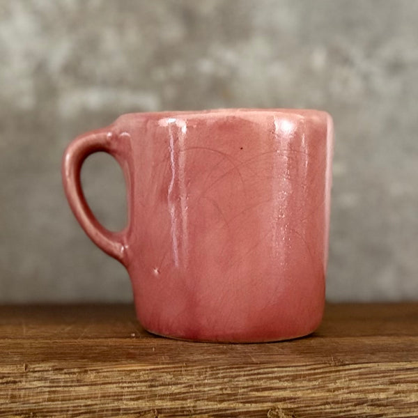 Small pink mug with words in Lithuanian