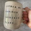 Two big ceramic mugs with words about work