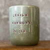 Green mug with words in Lithuanian