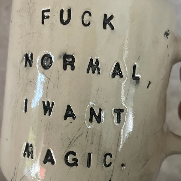 Ceramic mug with saying about magic