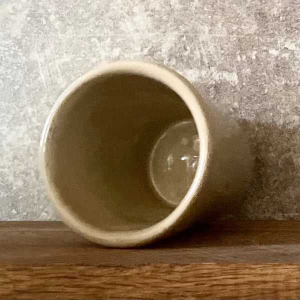 Puodelis su smagiu užrašu apie kavą ir kioskelį