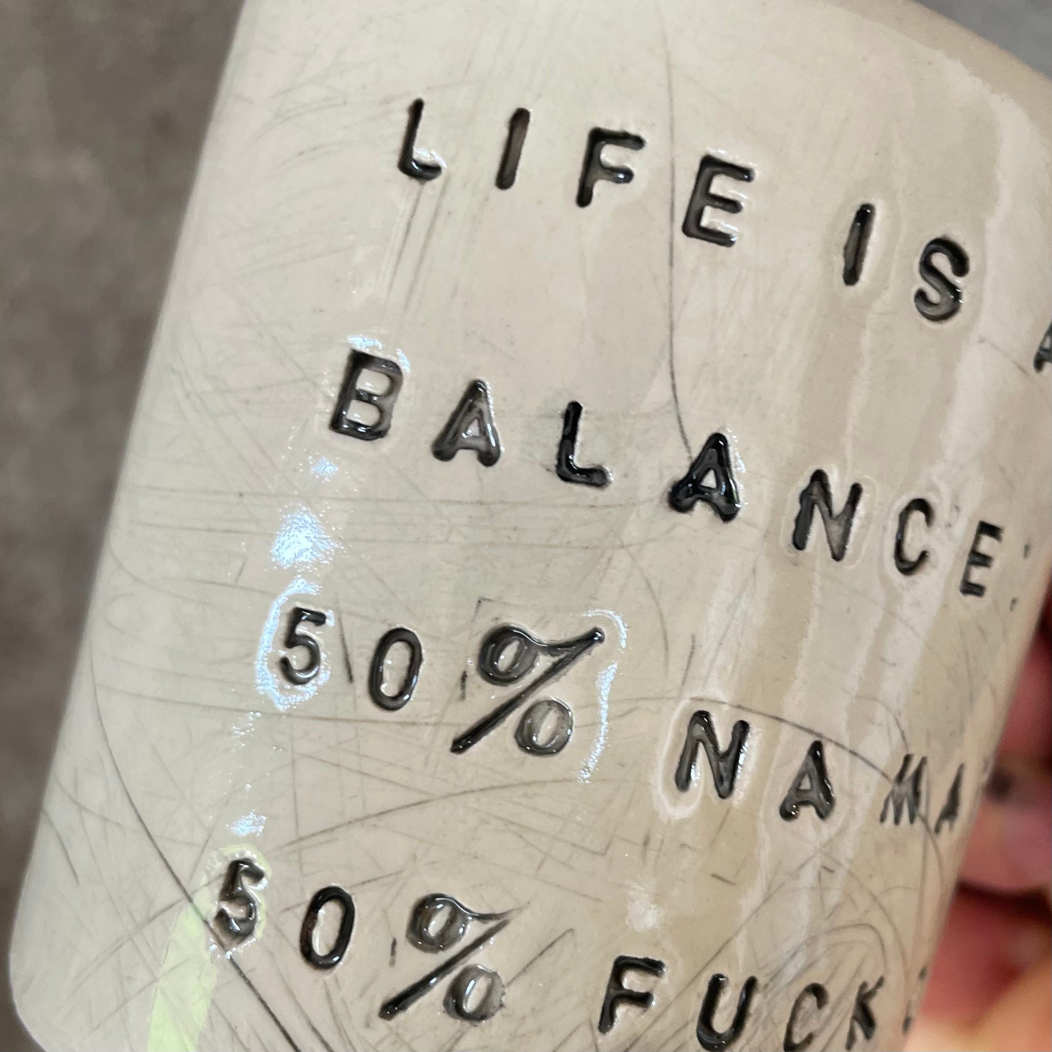 Ceramic mug with saying about balance with handle