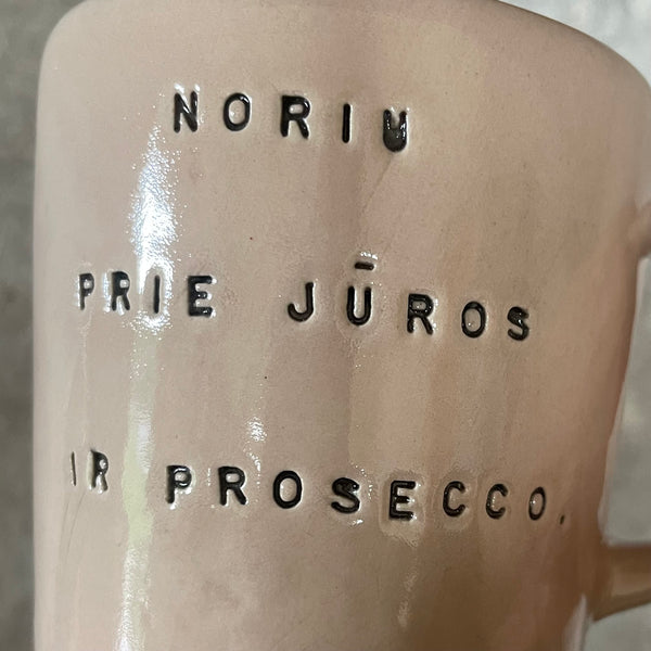 Pale pink mug with prosecco saying