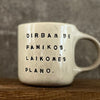 White irregular mug with words about work