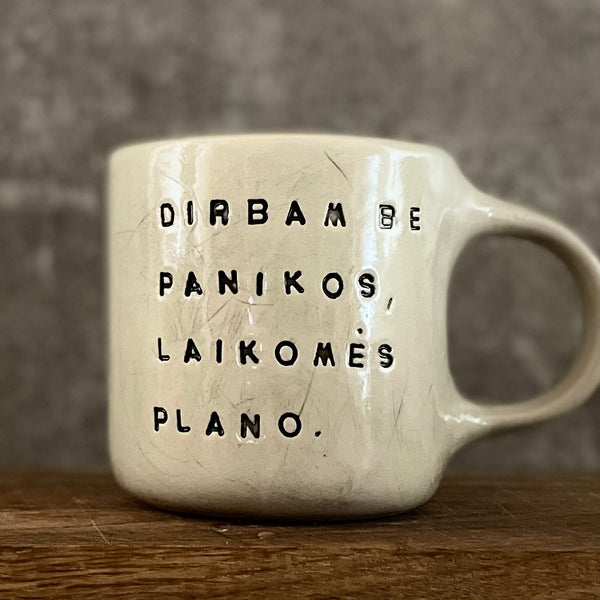 White irregular mug with words about work