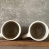 Two big ceramic mugs with words about work