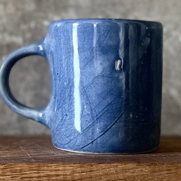 Blue ceramic mug about luck