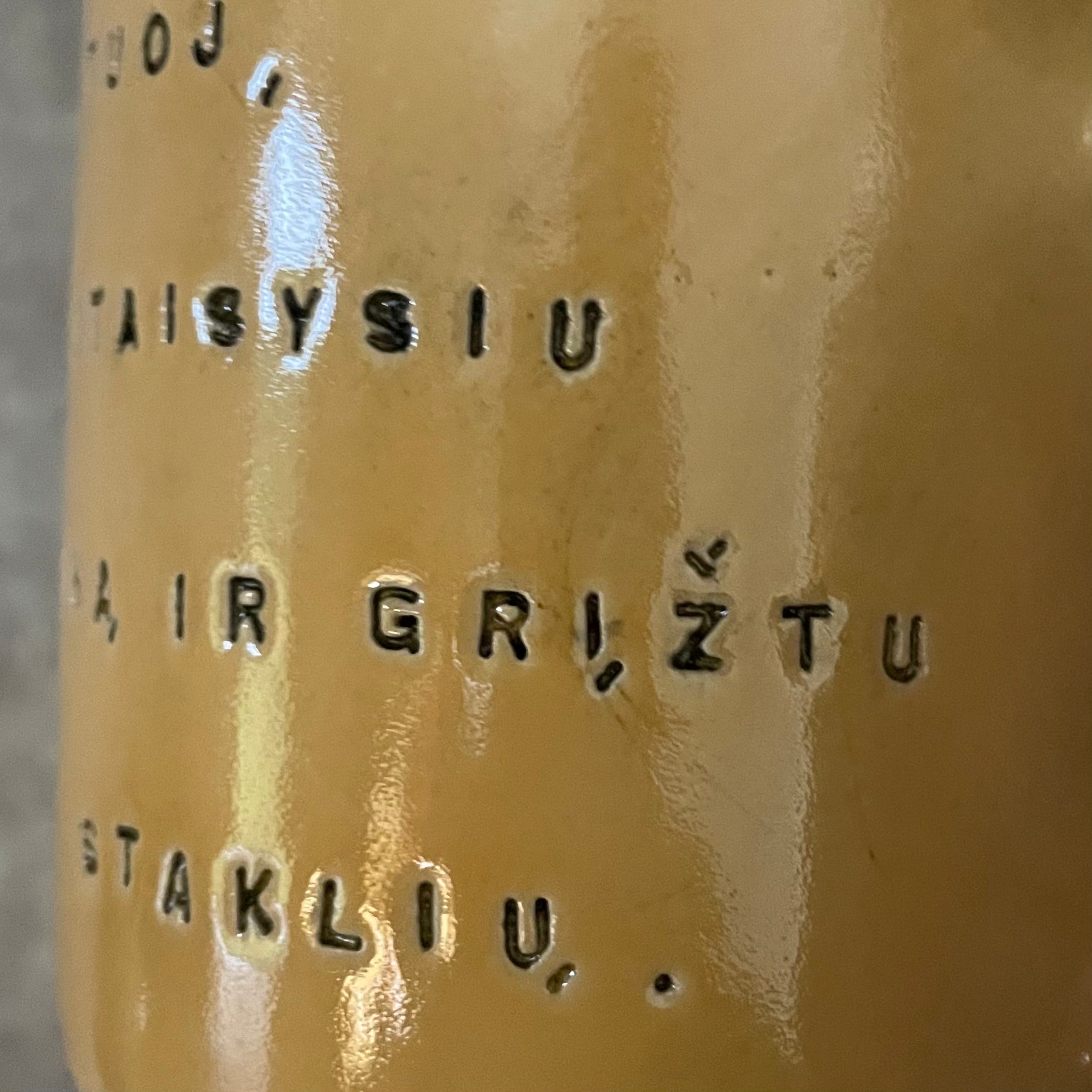 Yellow mug with words in Lithuanian