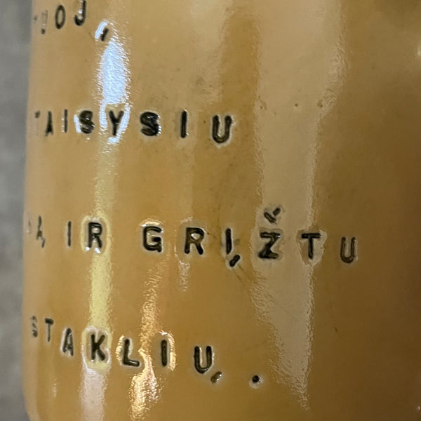 Yellow mug with words in Lithuanian