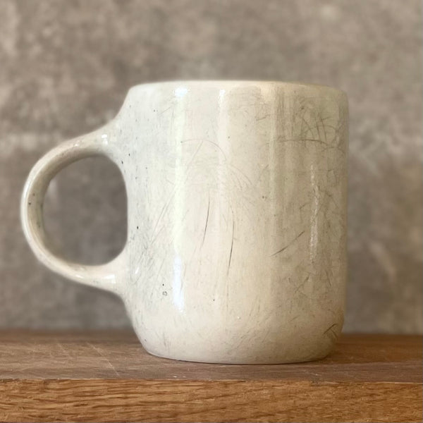 Speckled mug with words about work