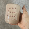 Large pink tumbler mug with text in Lithuanian