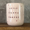 Large pink tumbler mug with text in Lithuanian