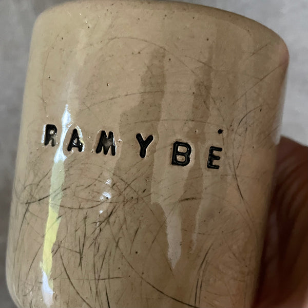 Beige tumbler mug with word RAMYBE
