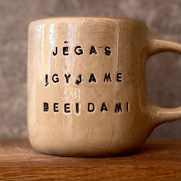 Beige ceramic mug with quote by Vergil