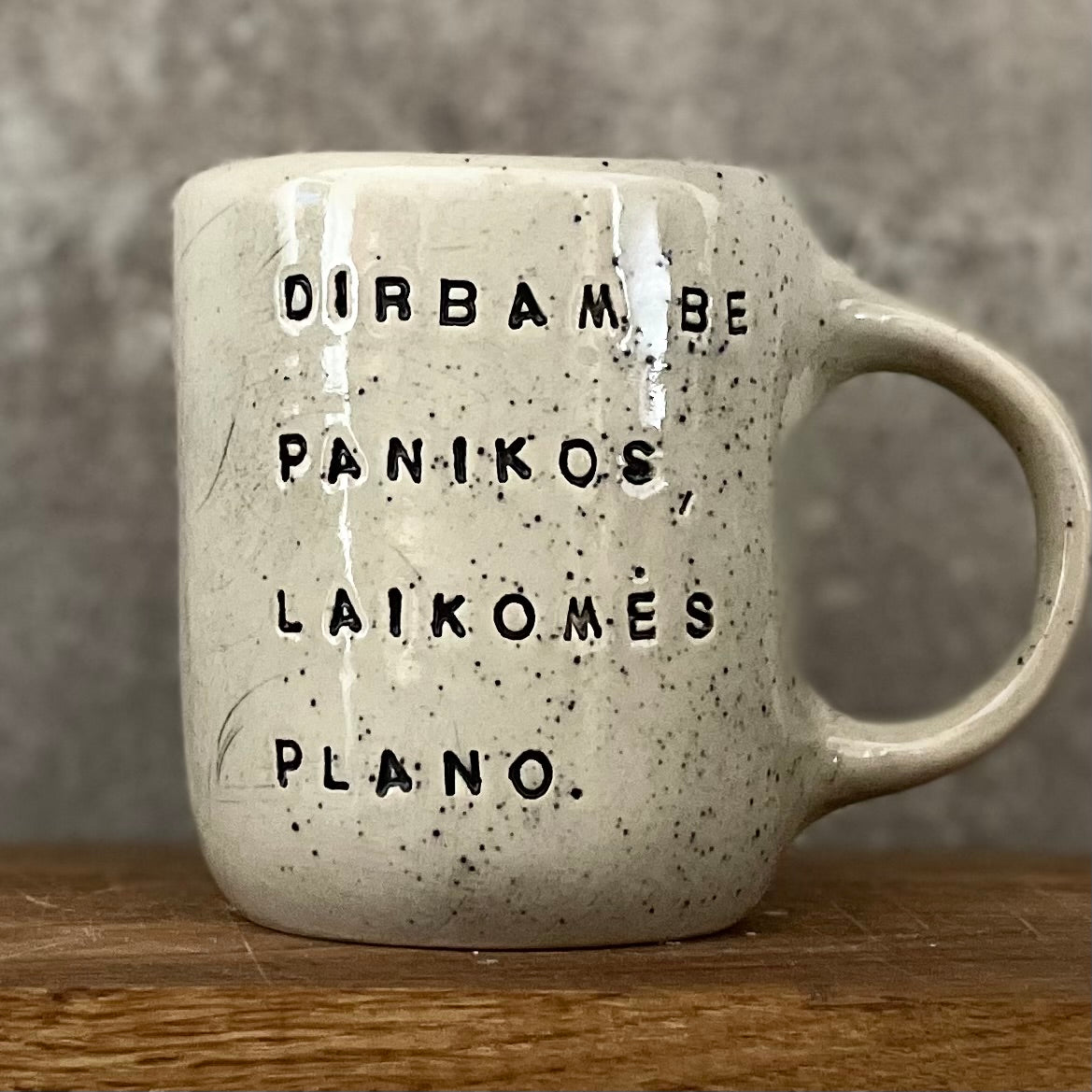 Speckled mug with words about work