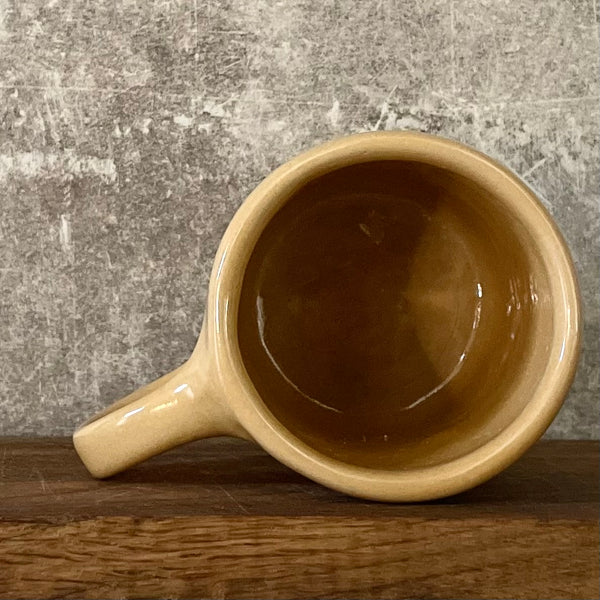 Yellow mug with words in Lithuanian