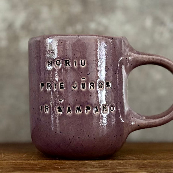 Small purple mug with words in Lithuanian