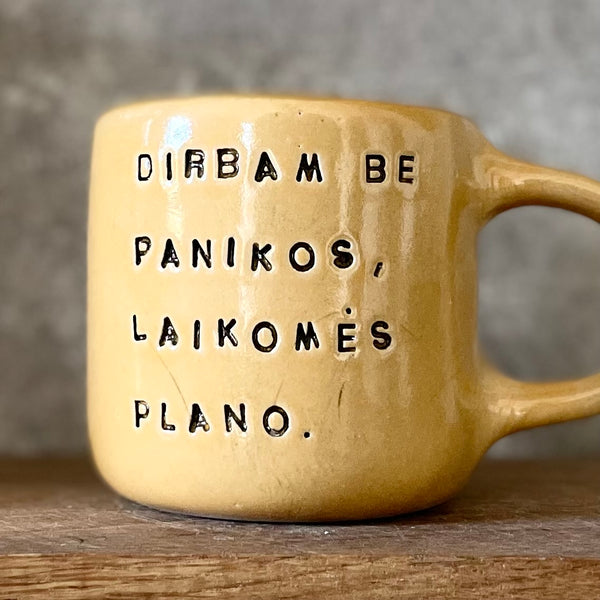 Yellow mug with words about work