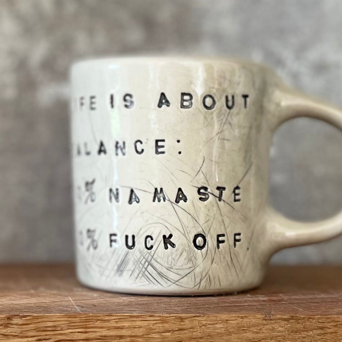 Ceramic mug with saying about balance with handle