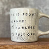Ceramic mug with saying about balance with handle