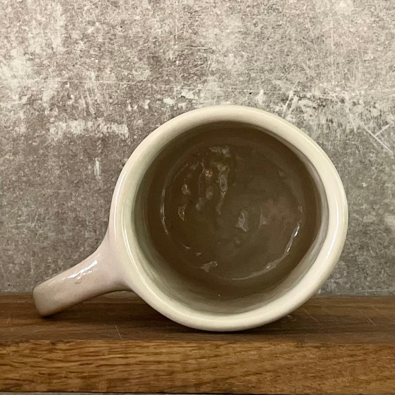 White irregular mug with words about work