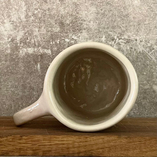 White irregular mug with words about work