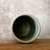 Green mug with words in Lithuanian