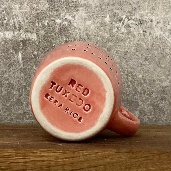 Small red mug with words in Lithuanian