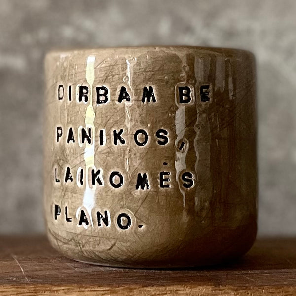 Dark brown tumbler mug with words about work