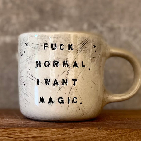 Ceramic mug with saying about magic