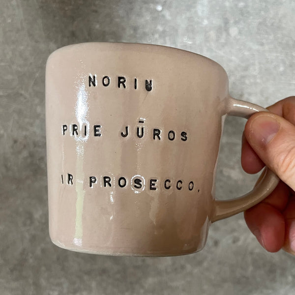 Pale pink mug with prosecco saying
