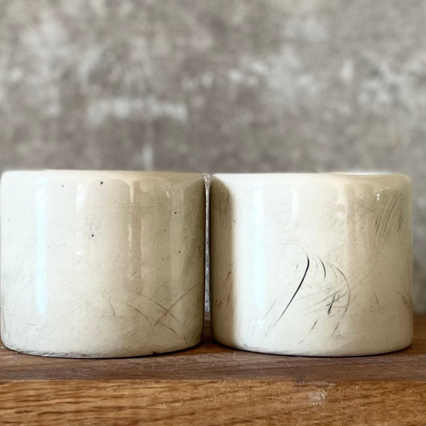 A set of small mugs with words in Lithuanian