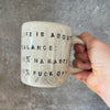 Ceramic mug with saying about balance with handle