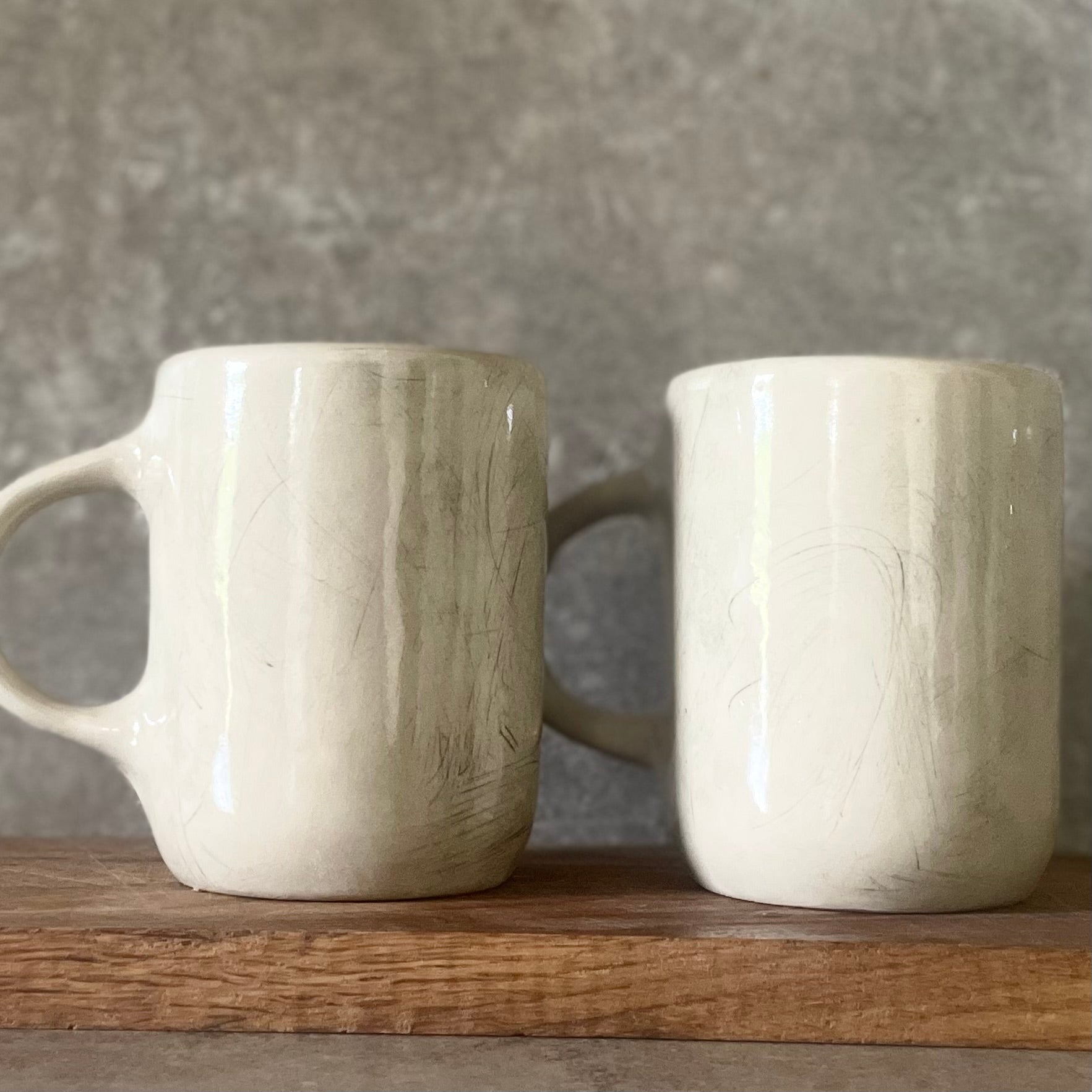 Two big ceramic mugs with words about work