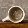 Ceramic mug with saying about magic