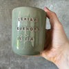 Green mug with words in Lithuanian