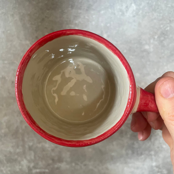 Puodelis su raudona rankena SKANIOS KAVELĖS