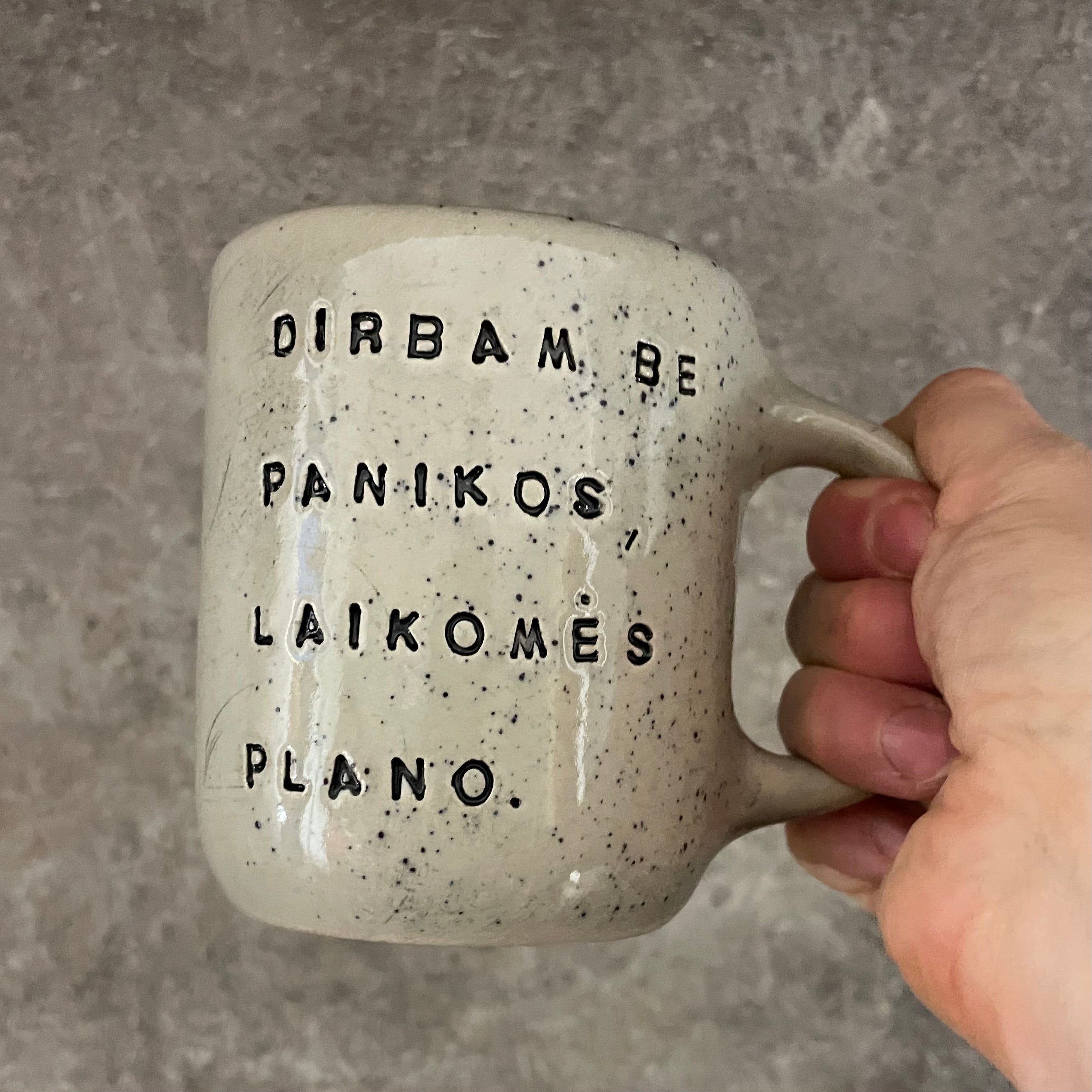 Speckled mug with words about work