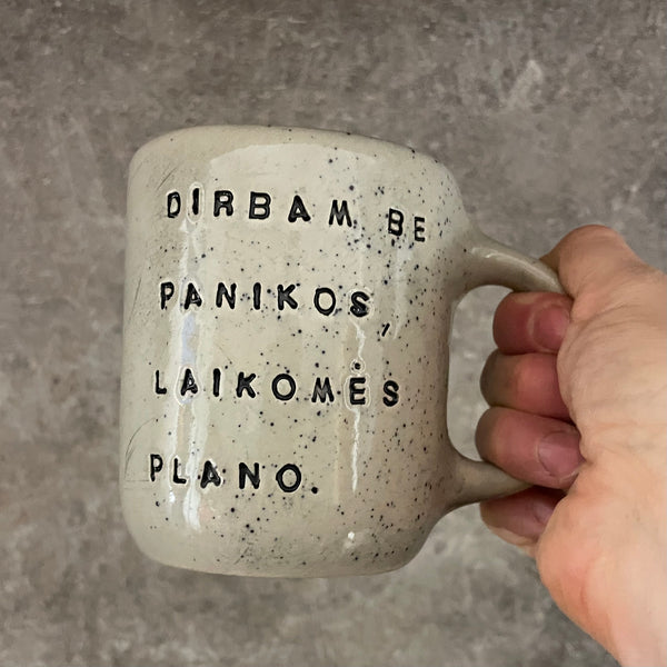 Speckled mug with words about work