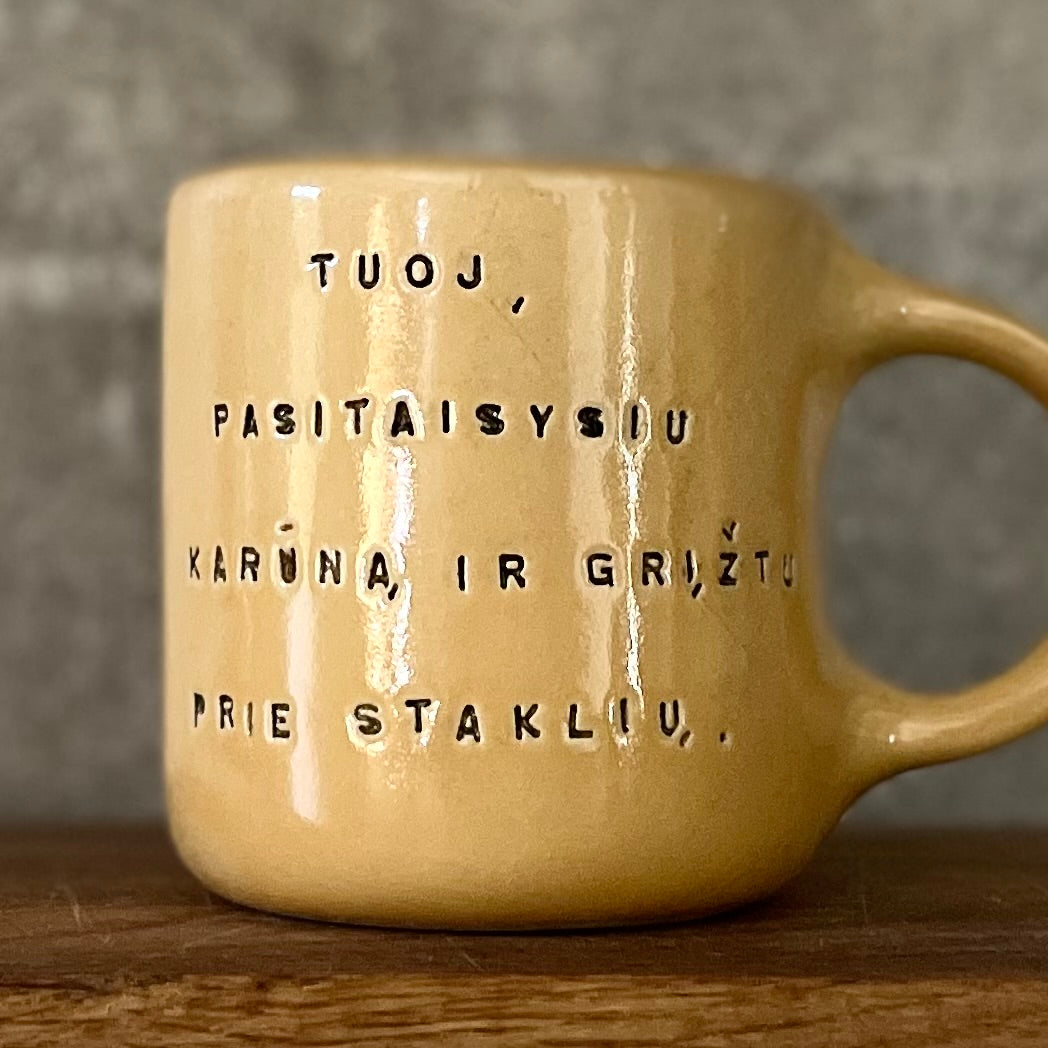 Yellow mug with words in Lithuanian