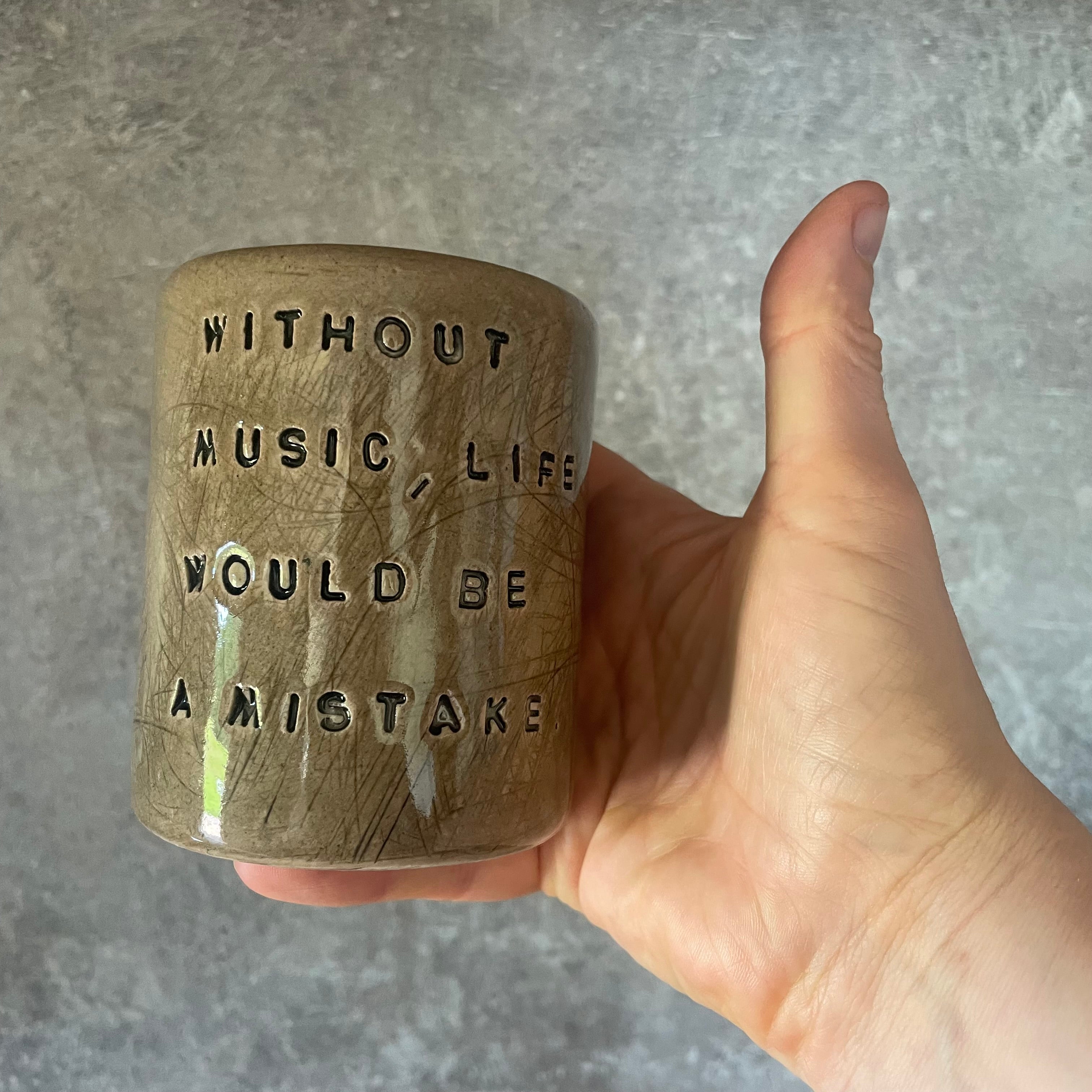 Brown mug with Nietzsche quote