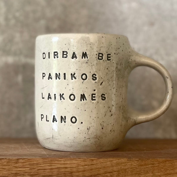 Speckled mug with words about work