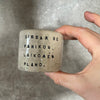 A set of small mugs with words in Lithuanian