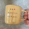 Yellow ceramic mug about luck