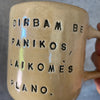 Yellow mug with words about work