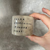 A set of small mugs with words in Lithuanian
